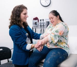 Doctor and patient with Down syndrome at an appointment