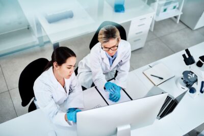 Two scientists looking at a computer